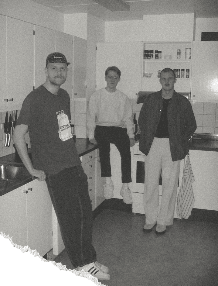 Group photo of the Koja Studio crew standing inside of a kitchen